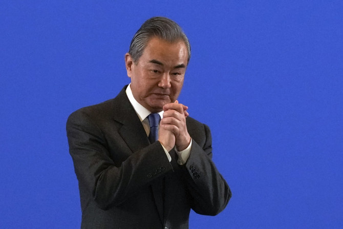 Chinese Foreign Minister Wang Yi gestures to the attendees after delivering an opening speech for a seminar on International Situation and China's Diplomacy in Beijing on Jan. 9, 2024. (AP)