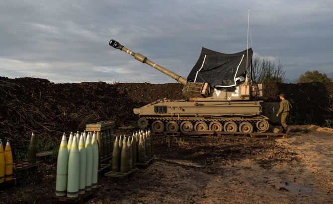 An Israeli soldier walks to a mobile howitzer in the north of Israel, near the border with Lebanon, Monday, Jan. 15, 2024. (AP Photo)