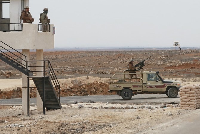 A File Photo picture taken during a tour organized by the Jordanian Army shows soldiers patrolling along the border with Syria to prevent trafficking (AFP)