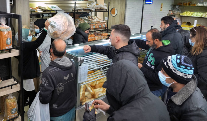 People queue for bread inside a bakery in the southern Beirut suburb of Dahiyeh, Lebanon, March 15, 2022. (AP)