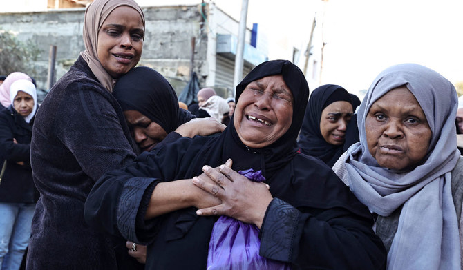 Relatives mourn during the funerals of some of the Palestinians in a refugee camp in Tulkarm in the occupied West Bank on Friday. They were killed during an Israeli raid. (AFP)