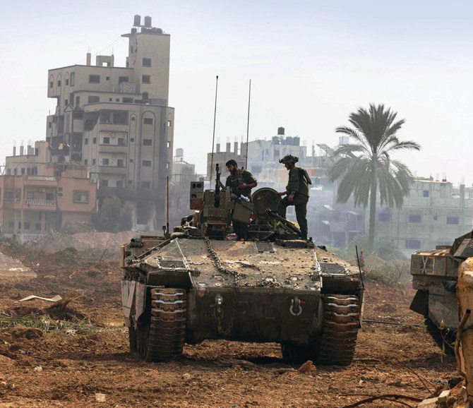 This picture taken during a media tour organized by the Israeli military on January 8, 2024, shows troops operating in the area of al-Bureij in the central Gaza Strip. (AFP)