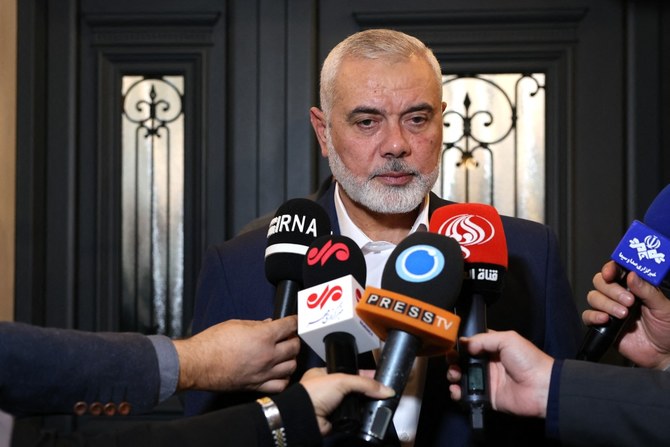 File Photo Qatar-based Hamas leader Ismail Haniyeh speaking to journalists (AFP)