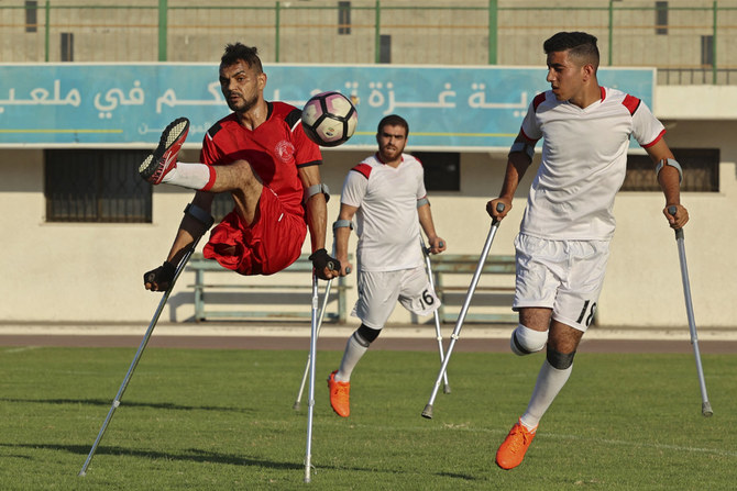 This photo taken on August 3, 2021, shows Palestinian amputee players compete during a football match at the Yarmouk Stadium in Gaza City on August 3, 2021. Israel’s 16-year blockade of the Gaza Strip and its ongoing military offensive have deprived people with disabilities of necessary assistive devices, such as wheelchairs and artificial limbs.(AFP)