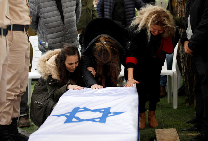 Friends and family mourn Israeli military reservist Sergeant Major Matan Lazar, 32, who was killed in the southern Gaza Strip amid the ongoing ground operation of the Israeli army against Hamas, at his funeral, in Haifa on Jan. 23, 2024. (Reuters)