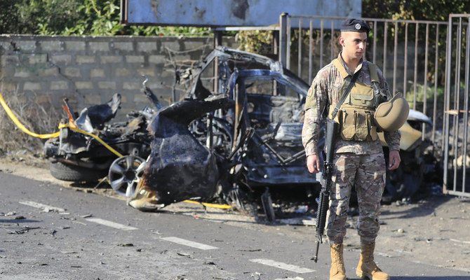 A Lebanese soldier stands next to a damaged car in the southern town of Bazouriyeh, Lebanon, Jan. 20, 2024. (AP)