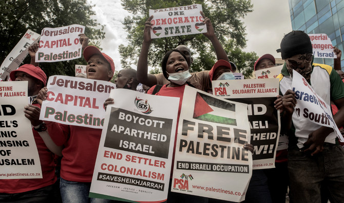 Members of General Industrial Workers Union of South Africa (GIWUSA), civil associations and political parties hold anti-Israel banners during a pro-Palestine demonstration in front of the Israeli Trade and Economic Office in Sandton, Johannesburg, on January 27, 2022. (AFP)