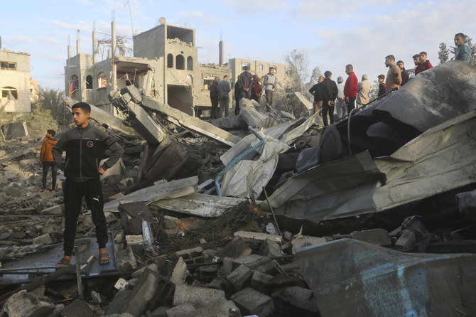 Palestinians look at a mosque destroyed in an Israeli strike in Rafah, Gaza Strip. on Jan. 24, 2024. (AP)