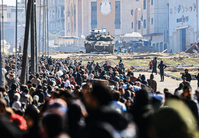 An Israeli tank guards a position as Palestinians flee Khan Younis in the southern Gaza Strip amid ongoing battles between Israel and Hamas. (AFP)