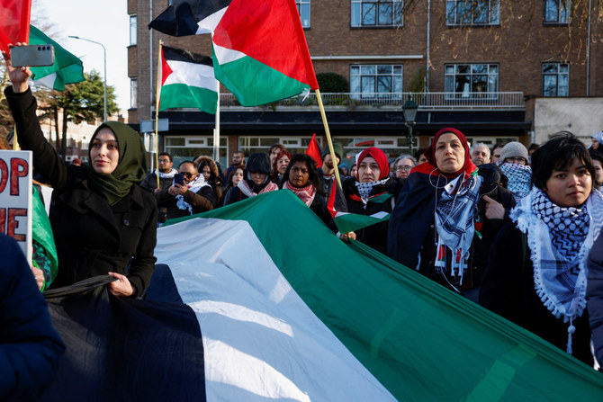 Pro-Palestinian demonstrators rejoice outside the World Court in The Hague on Jan. 26, 2024, as judges rule on emergency measures against Israel following accusations by South Africa that the Israeli military operation in Gaza is a state-led genocide. (REUTERS)