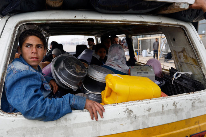 Palestinians fleeing Khan Younis due to the Israeli ground operation sit in a vehicle as they arrive in Rafah on Jan. 26, 2024. (Reuters)