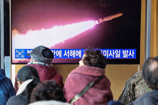 People watch a television screen showing a news broadcast with file footage of a North Korean missile test at a railway station in Seoul on Jan. 30, 2024. (Yonhap/AFP)