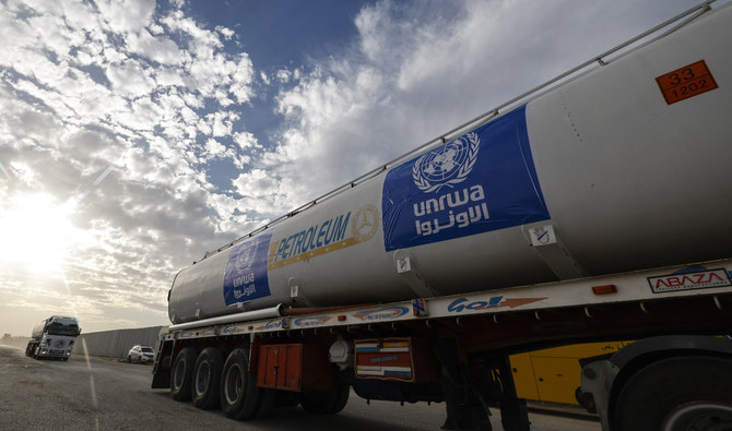 Trucks of the UN Relief and Works Agency for Palestine Refugees (UNRWA) carrying fuel arrive at the Egyptian side of the Rafah border crossing with the Gaza Strip on November 22, 2023. (AFP/File)