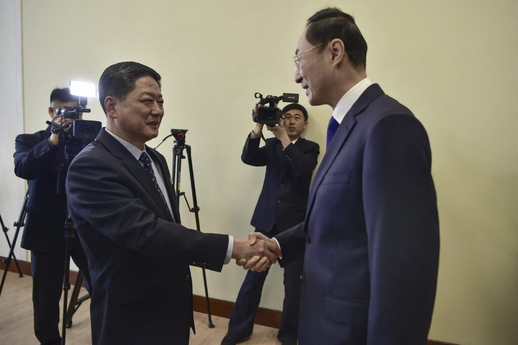 China's Vice Foreign Minister Sun Weidong (R) shakes hands with North Korea's Vice Foreign Minister Pak Myong Ho during a meeting at the People's Palace of Culture in Pyongyang on January 26, 2024. (AFP)