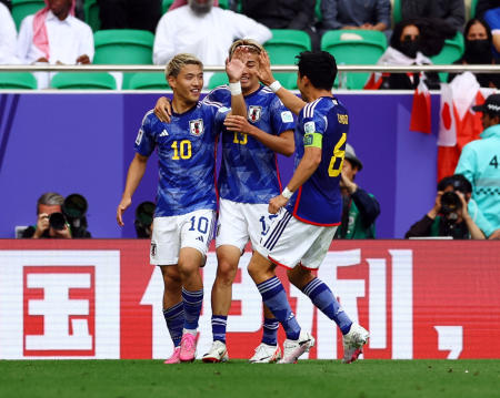 Japan's Ritsu Doan celebrates with Keito Nakamura and Wataru Endo after scoring their first goal against Bahrain. (Reuters)