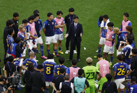 Japan coach Hajime Moriyasu speaks to the players and coaches after the match. (Reuters)