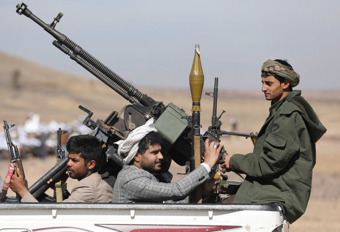 Tribesmen loyal to the Houthis ride on the back of a pick-up truck during a military parade for new tribal recruits amid escalating tensions with the U.S.-led coalition in the Red Sea, in Bani Hushaish, Yemen January 22, 2024. (Reuters)