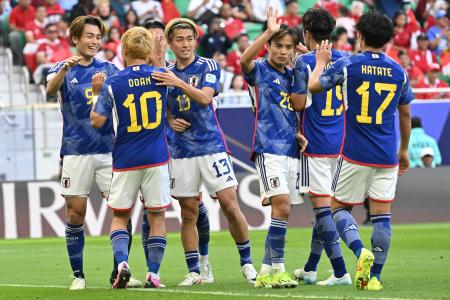 Japan's players celebrate after their second goal during the Qatar 2023 AFC Asian Cup Group D football match between Japan and Indonesia at al-Thumama Stadium in Doha on January 24, 2024. (AFP)
