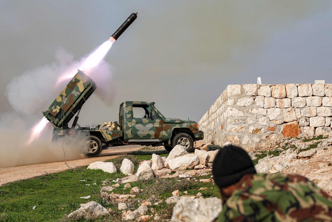 Syrian rebel fighters fire a rocket at government forces in Aleppo province on Jan. 1, 2024. (AFP)