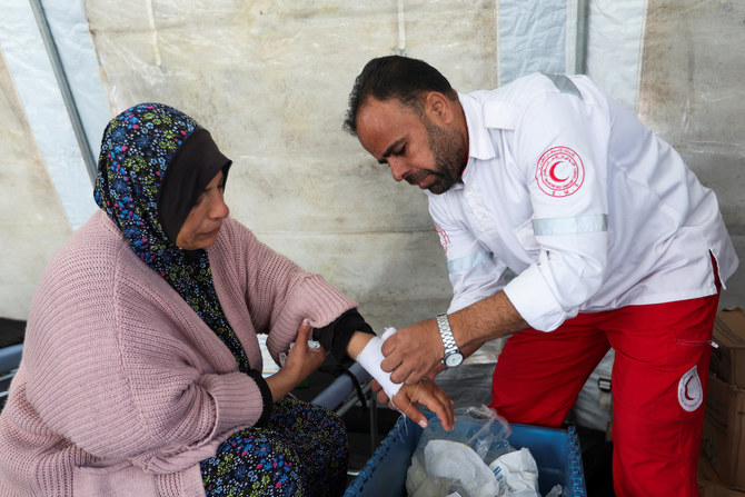 A medic helps a Palestinian woman at a medical point, formed to get better access to frontlines, in Khan Younis in the southern Gaza Strip January 30, 2024. (Reuters)