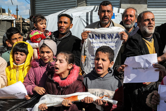 Palestinian men and children gather for a demonstration in Rafah in the southern Gaza Strip on January 30. (File/AFP)