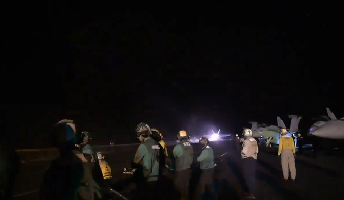 In this screen grab from a US Navy video, sailors watch as a fighter jet launches from the naval carrier USS Dwight D. Eisenhower in support of strikes on Iranian-backed Houthi targets in Yemen. (X: @CENTCOM)