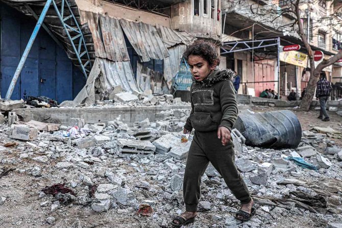 A girl walks through rubble in an area that was hit by reported Israeli bombardment in Rafah in the southern Gaza Strip on February 7, 2024. (AFP)