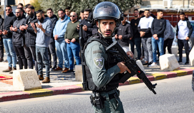 Palestinians offer Friday prayers on a street in East Jerusalem as age restrictions have been imposed to access the Al-Aqsa Mosque compound. (AFP)