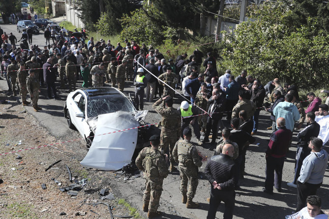 Lebanese army soldiers gather around a damaged car near the coastal town of Jadra, south Lebanon, Saturday, Feb. 10, 2024. (AP)