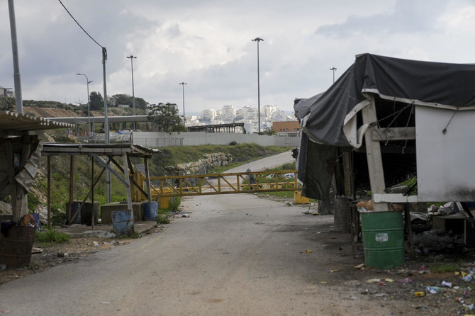 A closed gate seals the checkpoint where some 10,000 Palestinians used to cross into Israel every day for work, in Nilin, West Bank. The checkpoint has been closed since Oct. 7. when Israel barred Palestinians from entering the territory in response to a shock attack by Hamas militants on Israel. (AP)