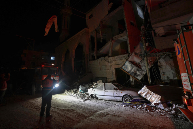 Rescue workers survey the scene following Israeli bombardments over Rafah in the southern Gaza Strip on February 12, 2024. (AFP)