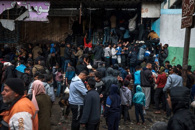 Palestinians crowd oustide a bakery to buy bread in Rafah on the southern Gaza Strip (AFP)