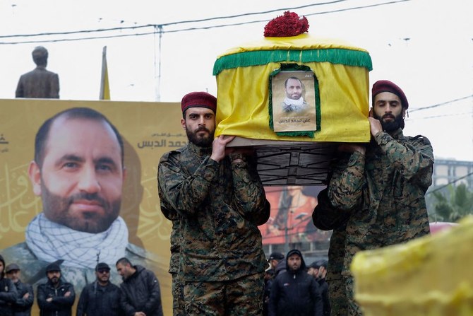 Hezbollah militants and supporters attend the funeral of Ali al-Debs, one of the militant group's commanders killed by an Israeli air raid two days earlier, in Lebanon's southern city of Nabatieyh on February 16, 2024. (AFP)