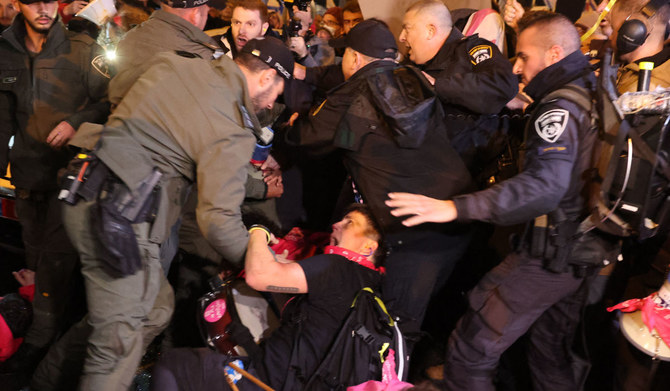 Israeli security forces dislodge a protester during an anti-government demonstration in Tel Aviv, on February 17, 2024, amid the ongoing conflict in the Gaza Strip between Israel and the Palestinian militant Hamas movement. (AFP)