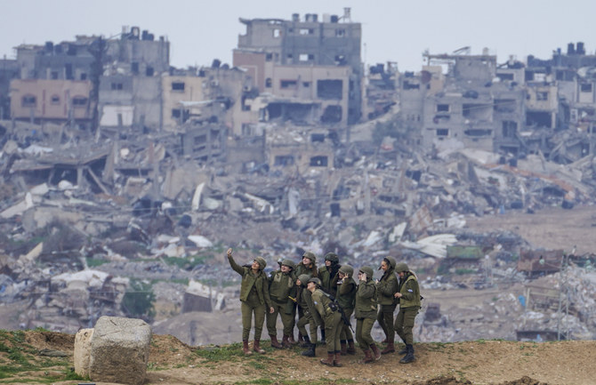 Israeli female soldiers pose for a photo on a position on the Gaza Strip border, in southern Israel, Monday, Feb. 19, 2024. (AP)