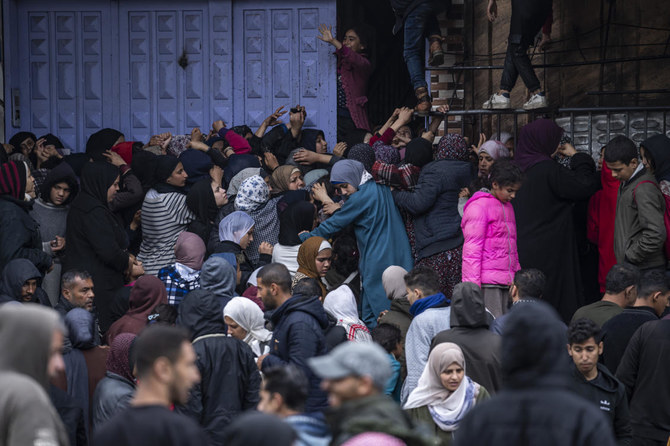 Palestinian crowds struggle to buy bread from a bakery in Rafah on Feb. 18, 2024. (AP)