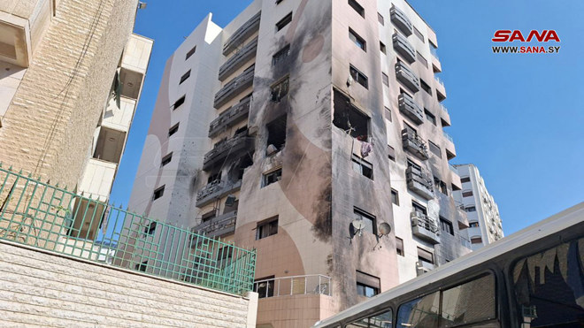 State news agency SANA published images of the purported aftermath of the attack, showing the outside of multi-story building partially blackened and windows blown out, with a fire visible in one apartment that appeared to have been targeted. (SANA)
