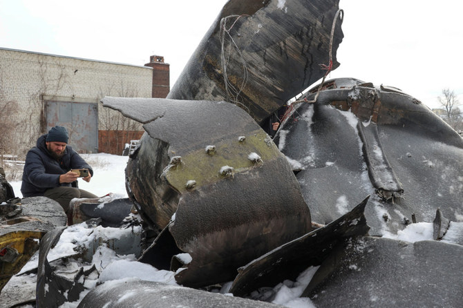 A man photographs parts of an unidentified missile, which Ukrainian authorities believe to be made in North Korea and was used in a strike in Kharkiv in early January. (REUTERS/File Photo