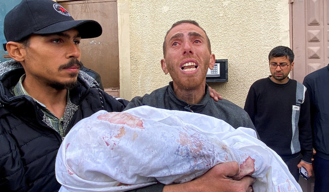 Ahmed Azam carries the body of his son Muhanad, who was born in the Israel-Hamas war and killed in an Israeli strike, at Al-Aqsa Hospital in Deir Al-Balah in the central Gaza Strip. (Reuters)