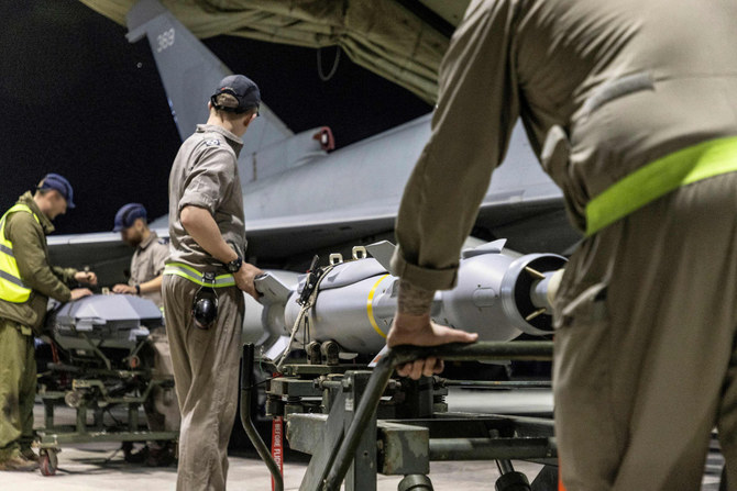 A handout picture released by the British Ministry of Defende on Feb. 24, 2024 shows a Royal Air Force Typhoon FGR4 having Paveway IV weapons loaded at RAF Akrotiri in Cyprus, in preparation for a strike on military targets in Yemen. (MOD handout via AFP)