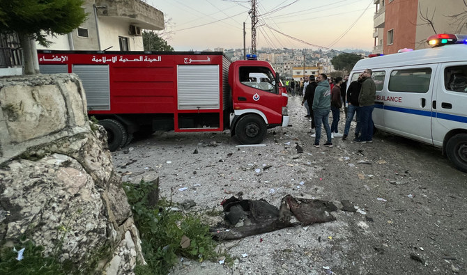 An ambulance and a fire engine rush to the scene where an Israeli drone shot two guided missiles at a building in Kfar Rumman near south Lebanon’s town of Nabatiyeh on February 22, 2024, reportedly killing at least 2 Hezbollah fighters. (AFP/File)