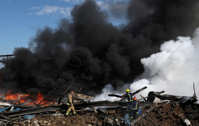 Firefighters work as smoke billows at a site that was hit by an airstrike on Monday, after what Lebanon's state media said was a series of Israeli strikes around Ghaziyeh on Lebanon's coast around 60 km north of the border with Israel, during a media tour, Lebanon February 20, 2024. (Reuters)