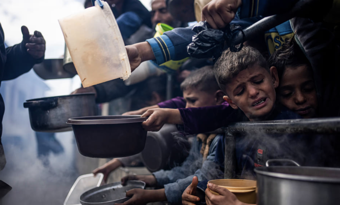 Palestinians line up for a free meal in Rafah, Gaza Strip, earlier in February. (AP)