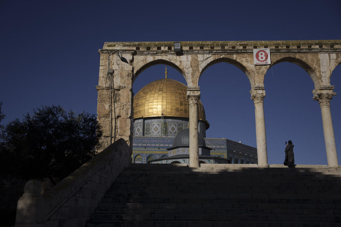 A Muslim woman uses her phone to take a picture of the Dome of the Rock shrine, at the Al Aqsa Mosque compound in the Old City of Jerusalem, on Feb. 29, 2024. (AP)