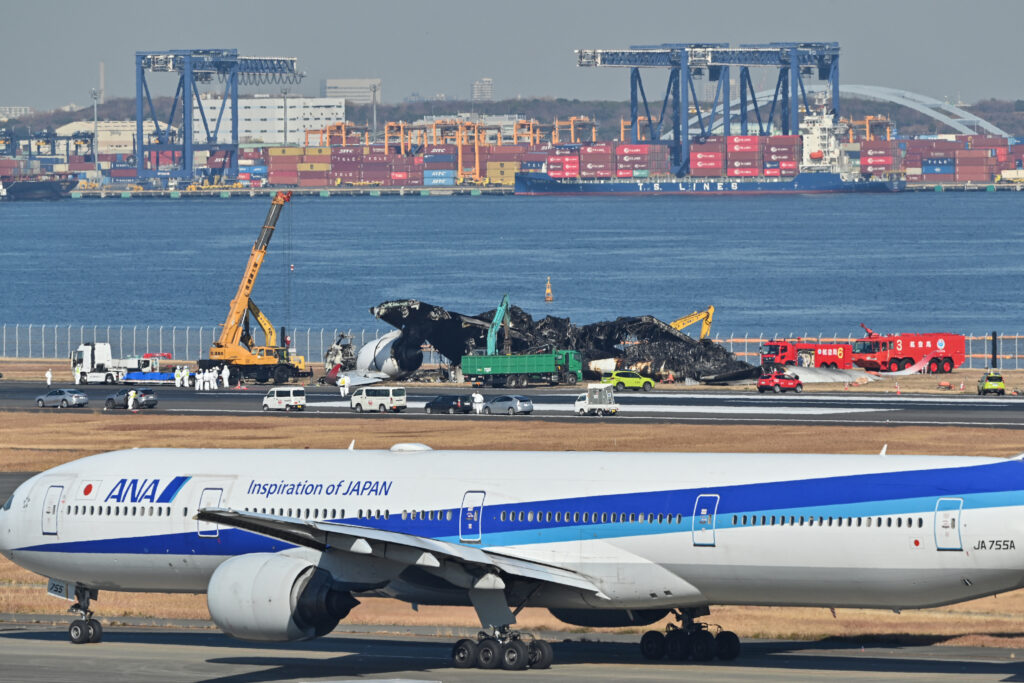 The JAL flight is believed to have moved in the wrong direction, although it recognized an instruction from an air traffic controller telling it to wait on a taxiway. (AFP)