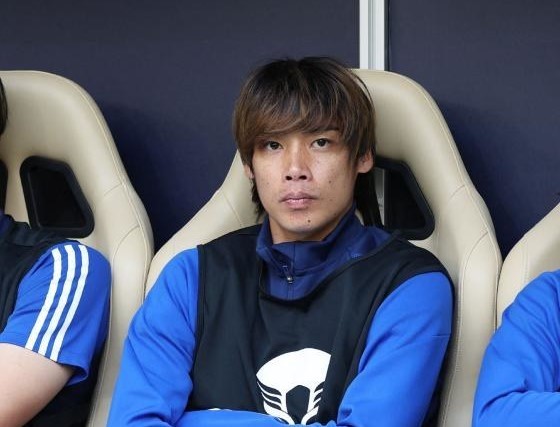 Japan’s midfielder Junya Ito is seen on the bench before a football match of the Qatar 2023 AFC Asian Cup against Bahrain at Al-Thumama Stadium in Doha on Jan. 31, 2024. (AFP)