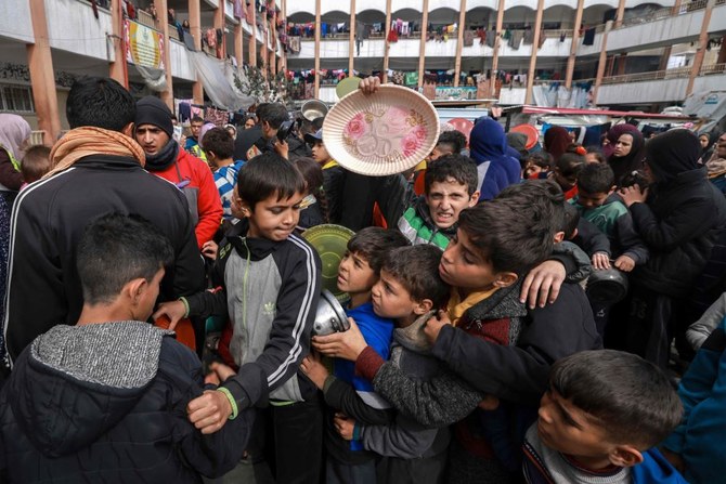 Displaced Palestinian children gather to receive food at a government school in Rafah, southern Gaza Strip, Feb. 19, 2024. (AFP)