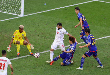 Japan's Kou Itakura fouls Iran's Hossein Kanani to concede a penalty. Itakura was inconsolable after the game, disappearing straight down the tunnel and later blaming himself for the defeat. (Reuters)