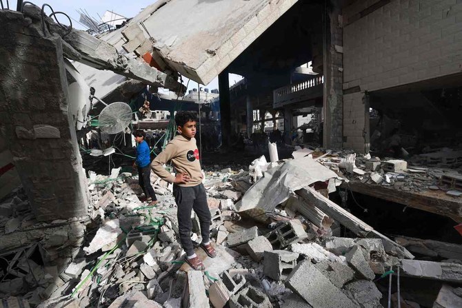 People inspect the damage in the rubble of a mosque following Israeli bombardment, in Rafah, on the southern Gaza Strip on February 12, 2024. (AFP)