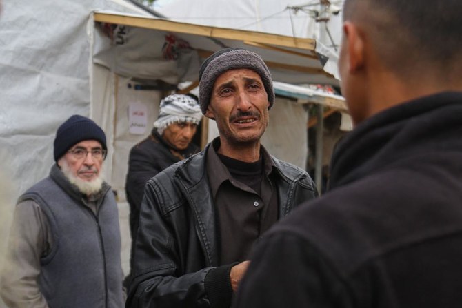 Palestinians react at the Al-Aqsa Martyrs Hospital in Deir Al-Balah where relatives pulled from the rubble of the Tabatibi family home were transported on Mar. 16, 2024. (AFP)